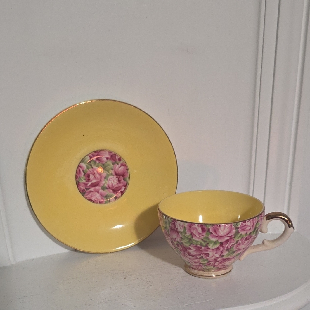 This is a Royal Leighton Chintz footed teacup and saucer set in yellow with pink